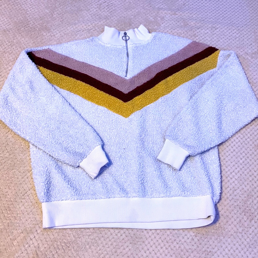 White pull over with design.